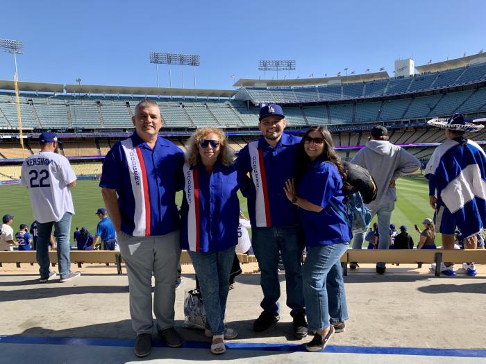 Group wearing blue custom Dodgers themed bowling shirts at a baseball stadium