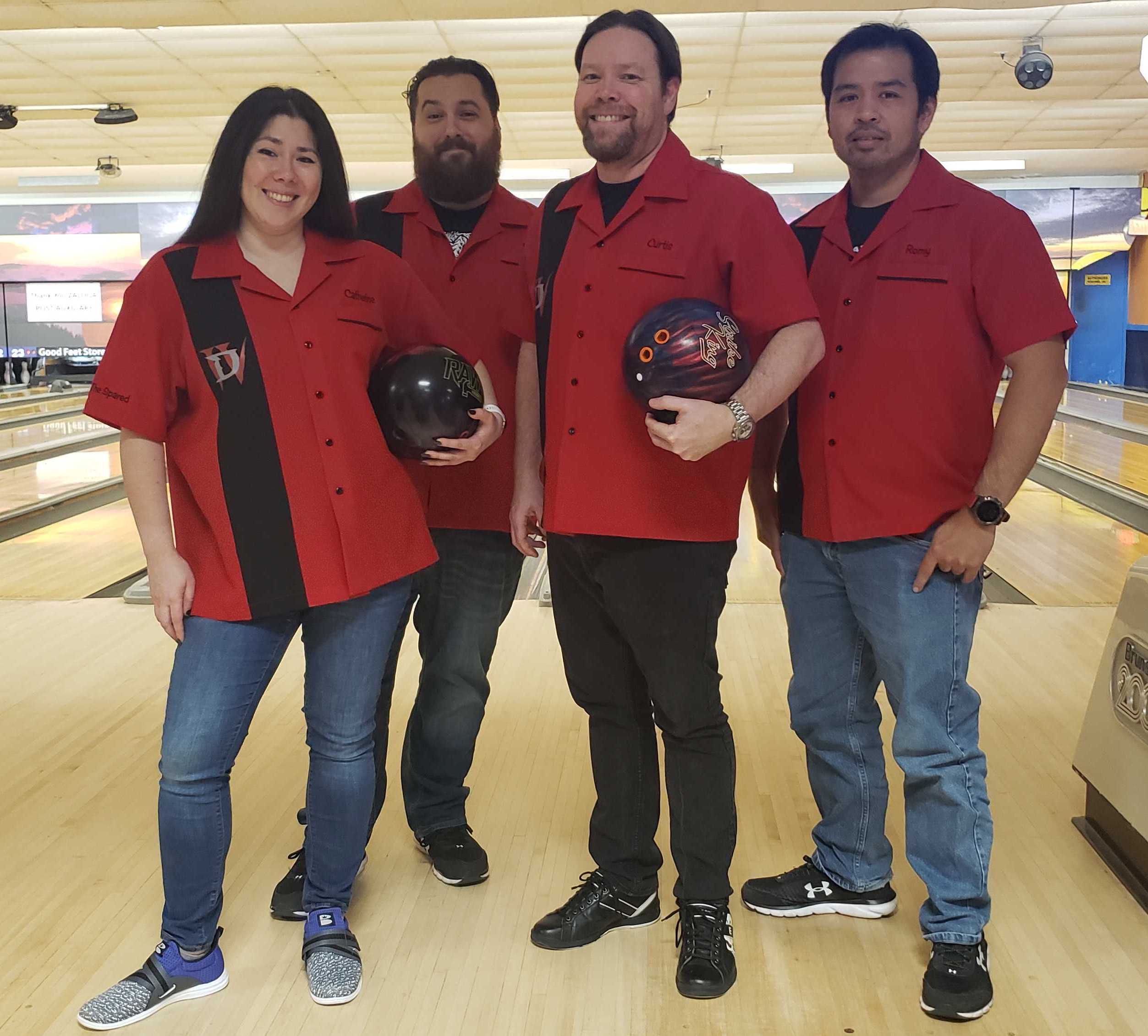 Custom red and black bowling shirts team posing on the lanes – USA made retro style