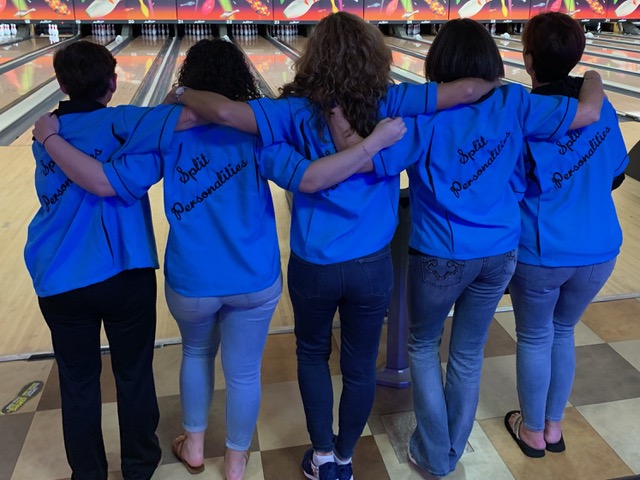 Split Personalities women's bowling team wearing custom blue shirts with arms around each other on the lanes – USA made