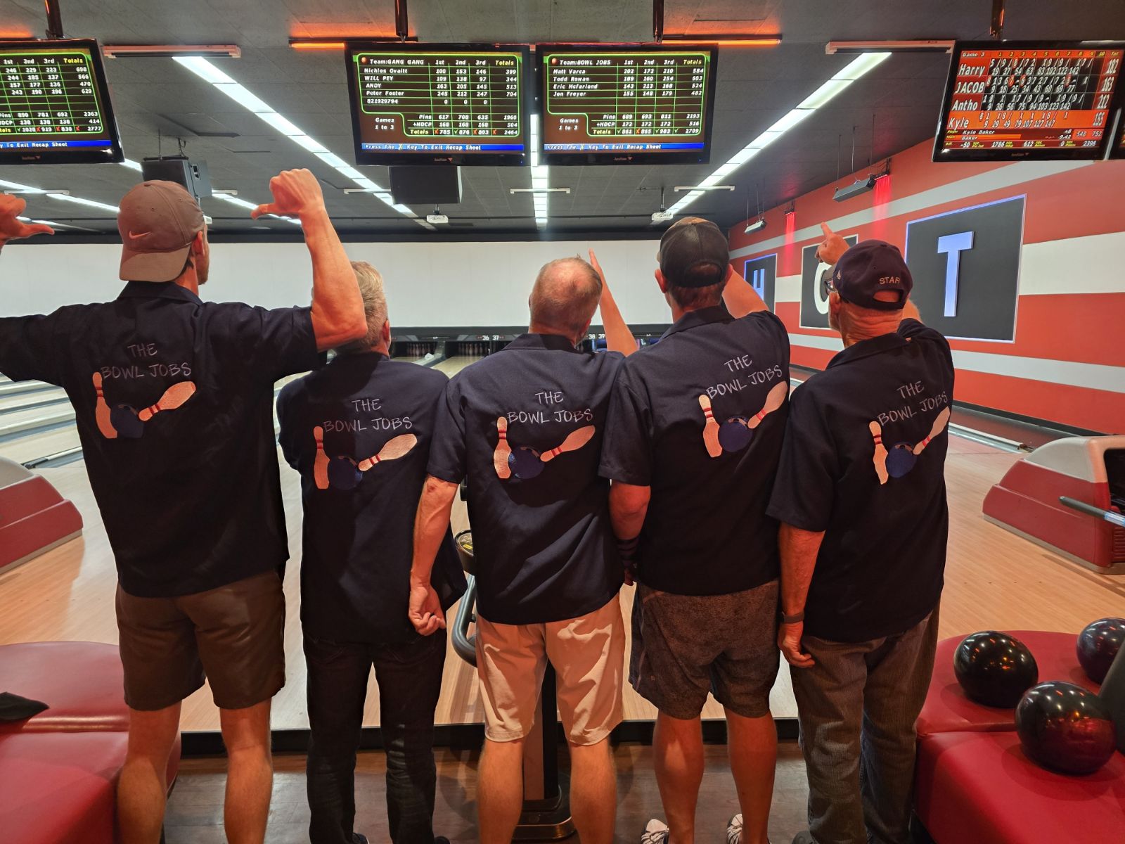 The Bowl Jobs team showing custom back printing on navy bowling shirts on the lanes – USA made